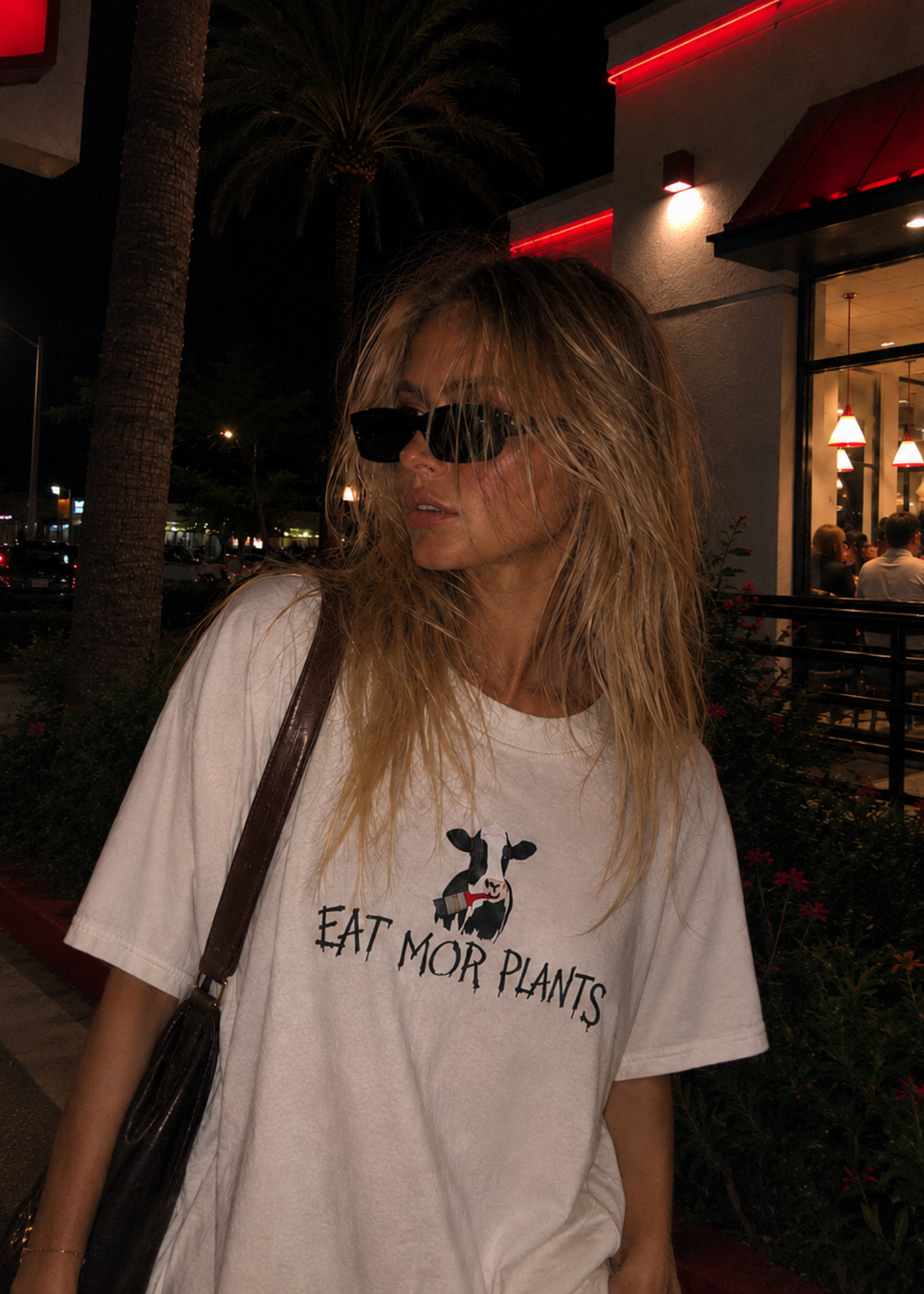 Girl wearing an eat mor plants cow t shirt  vegan streetwear 